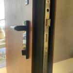 pivot entry door hardware detail with black handle and secure lock system